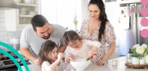 Parents and two children cooking in a kitchen