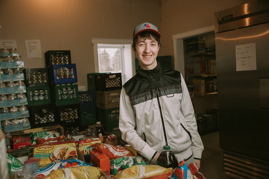 Deven Stewart standing in a kitchen with food on the table beside him