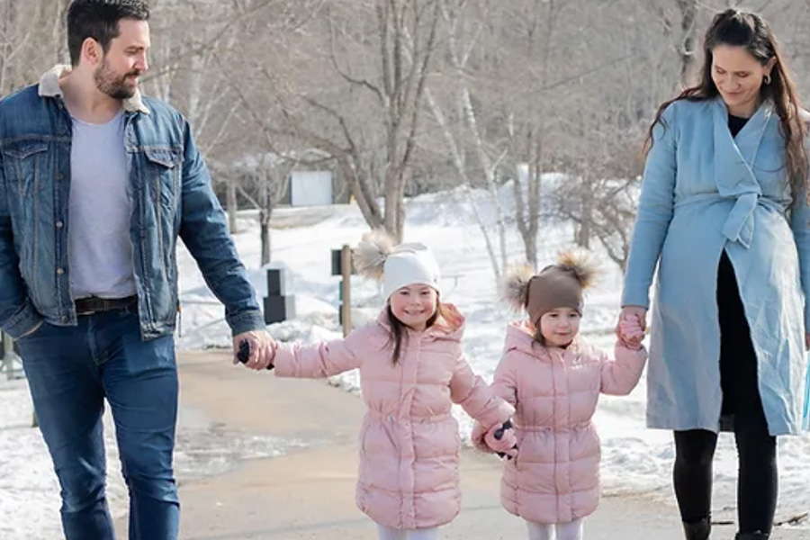 Couple walking outside with their daughters